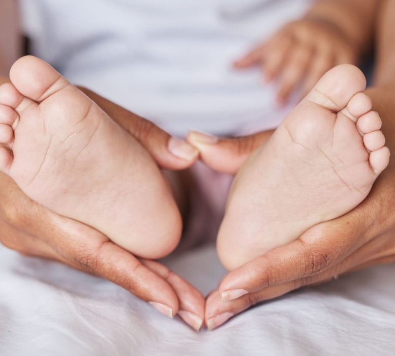 Closeup, feet and baby with mother, hands and care for kid, support and touch for bonding and playf.