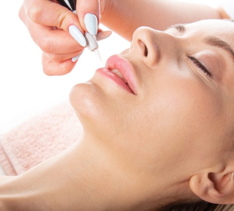 Closeup lip color correction progress by beauty expert.