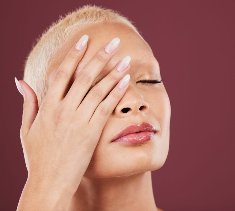 Eyes closed, hands and face skincare of woman in studio isolated on a red background mockup. Dermat.