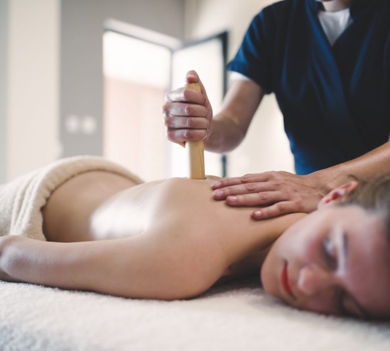 Thai massage therapist treating patient at healthcare salon